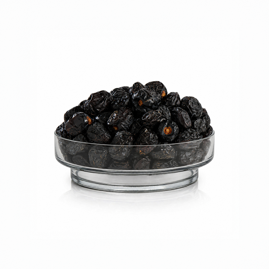 Premium Ajwa Dates in a glass bowl on a white background, original Ajwa Khajoor from Madinah Saudi Arabia